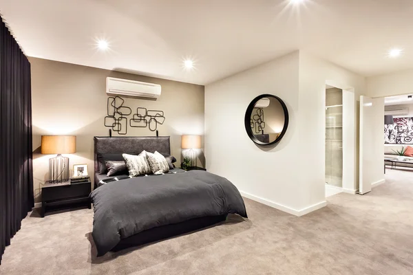 Modern bedroom with a round mirror and hallway — Stock Photo, Image