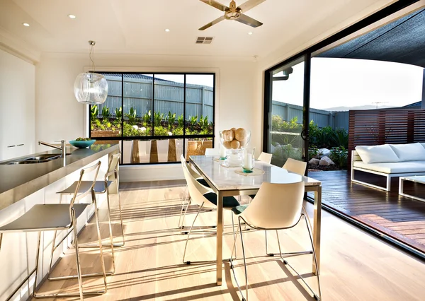 Modern kitchen and dining area on the wooden floor — Stock Photo, Image