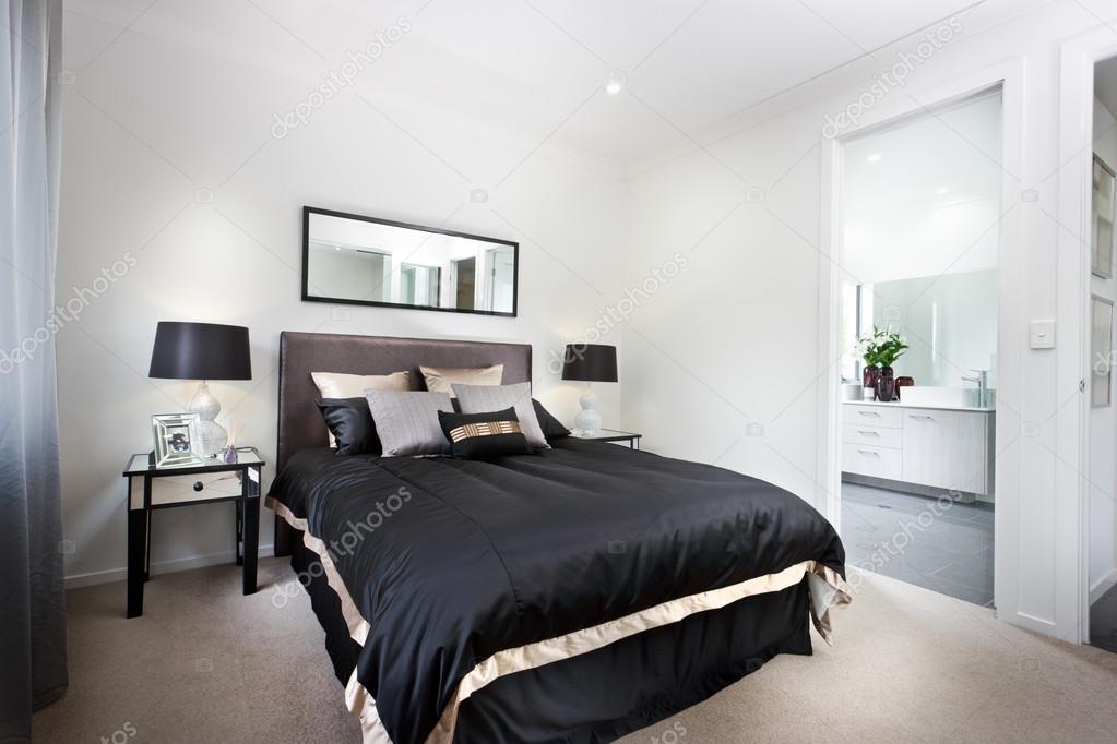 Luxury bedroom including black duvets and washroom  entrance 