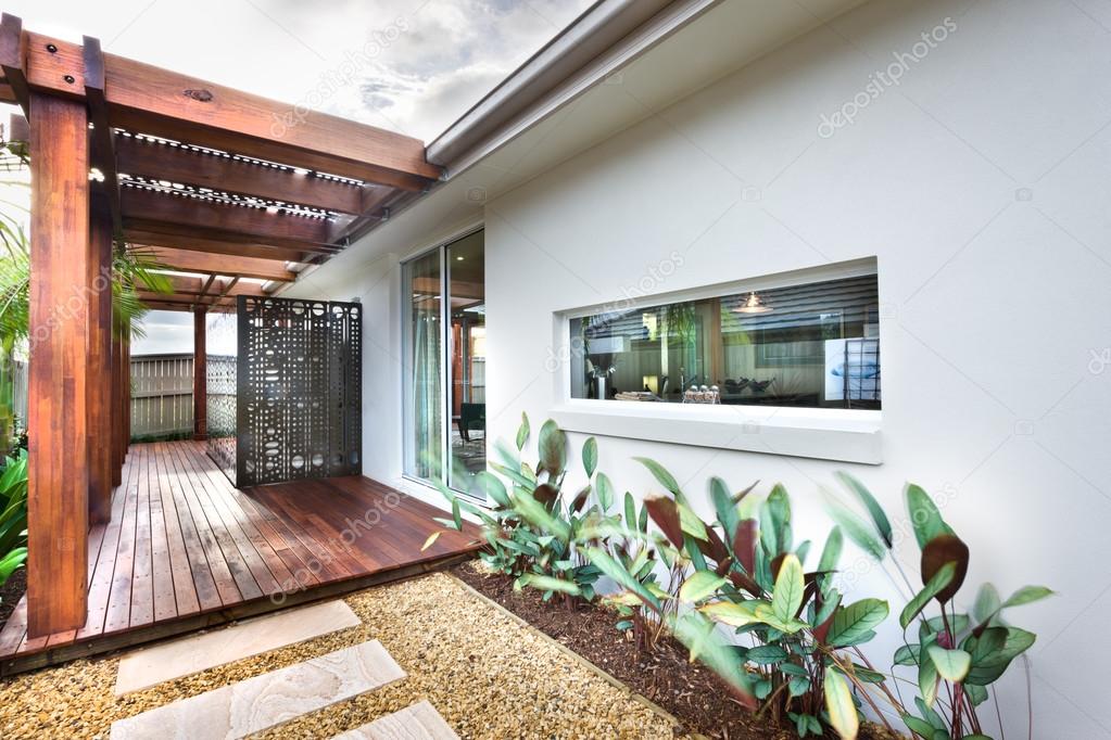 Beautiful picture of lawn with wooden floor and garden