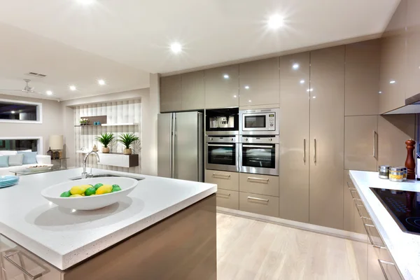 Modern kitchen area illuminated with lights at night — Stock Photo, Image