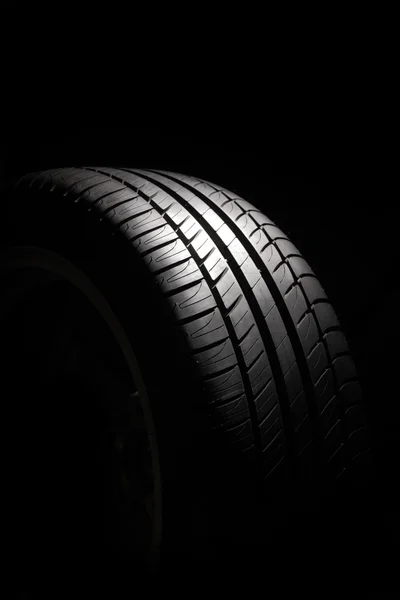 Tire on black background — Stock Photo, Image