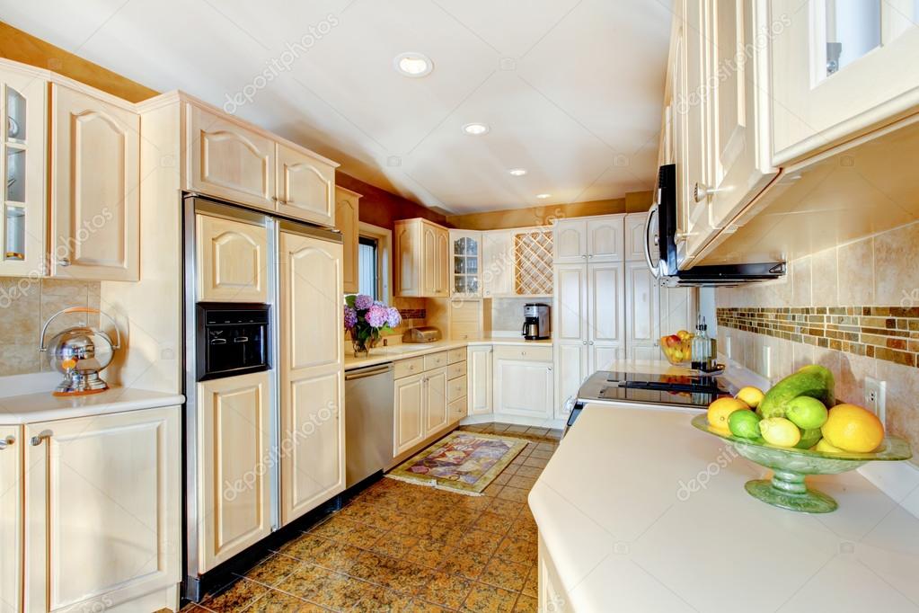 Luxury Kitchen With Cream Cabinets luxury kitchen with cream cabinets and white counter tops stock photo