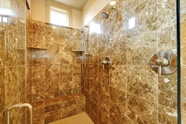 Bathroom shower with marble wallls and window — Stock Photo, Image