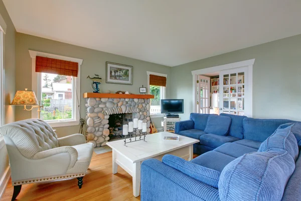 Klasický americký obývací pokoj s modrou pohovkou a krb. — Stock fotografie