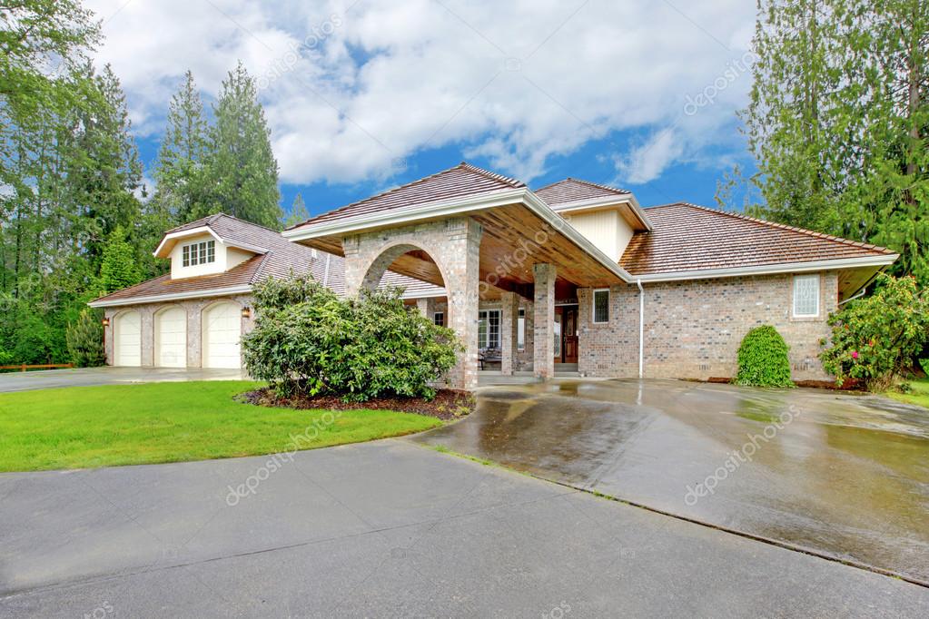 Beautiful Curb Appeal After Rain Large Brick House With Three Garage Spaces And Driveway With Arch Beautiful Curb Appeal After Rain Large Brick House With Three Garage Spaces And Driveway With Arch