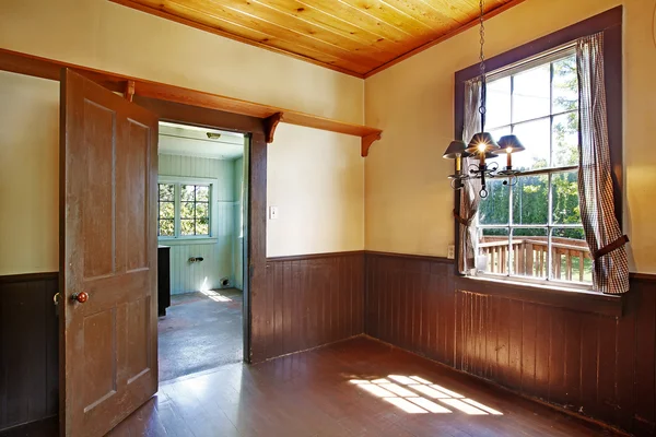 Antique kitchen room interior with yellow walls and brown plank panel trim . — Stock Photo, Image