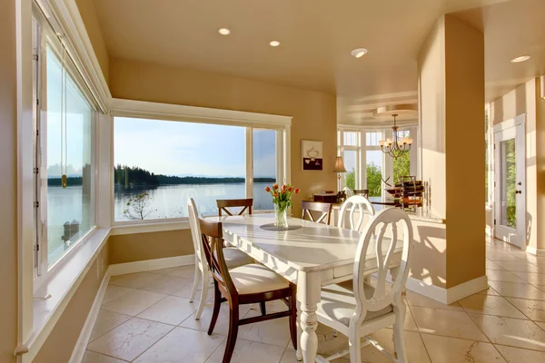 Dining room interior with white table set and tile floor. — Stock Photo, Image