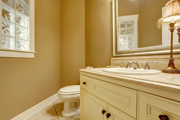 Cozy bathroom interior with decorative lamp on old white cabinets. — Stock Photo, Image