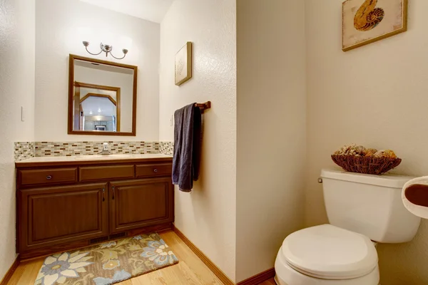 Интерьер ванной комнаты. Вид коричневого шкафа с зеркалом и туалетом . — стоковое фото