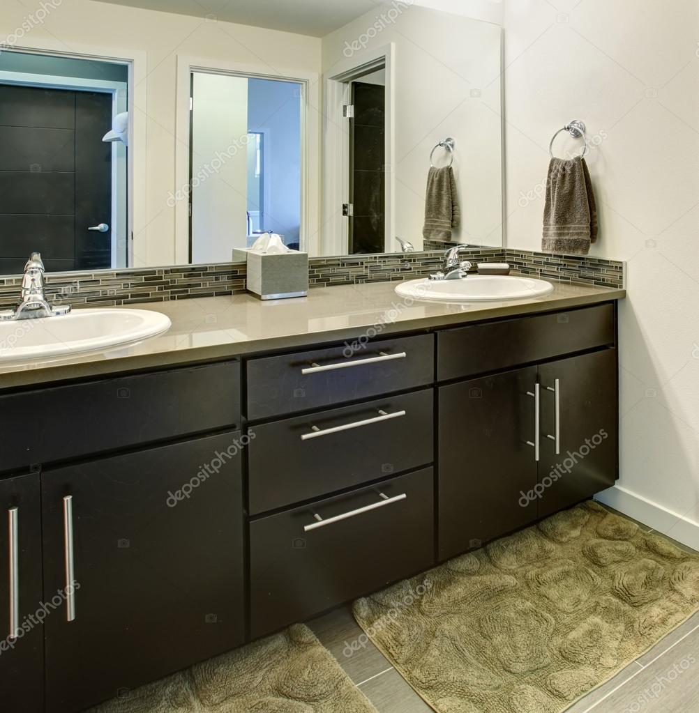 Bathroom Interior With Black Cabinets Two Sinks And Large Mirror