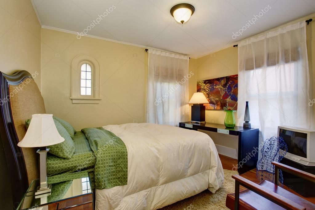 Small Beige Bedroom Interior With Hardwood Floor And Green