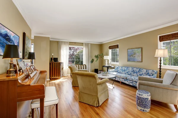 Salón americano interior con piano, sofá azul y suelo de madera . — Foto de Stock