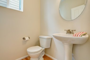 White bathroom interior with toilet and washbasin stand