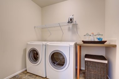 Small laundry room with white appliances and wicker basket clipart