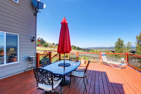 Deck de madeira walkout com mesa de pátio com vista para a bela paisagem — Fotografia de Stock