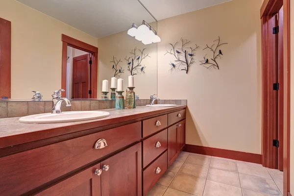 Moderno bagno interno con mobili in legno di ciliegio e pavimento piastrellato — Foto Stock