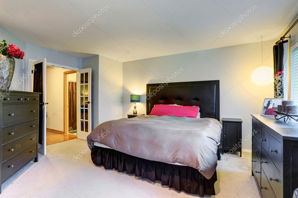 Master Bedroom With Black Furniture Set And Carpet Floor Stock