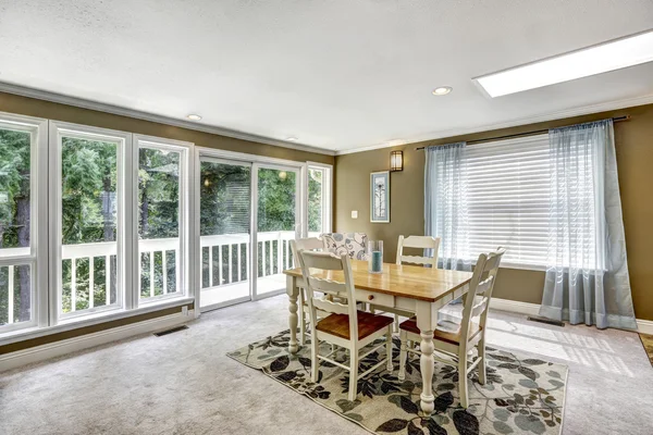 Nice dining room interior with soft blue curtain and floral carpet.