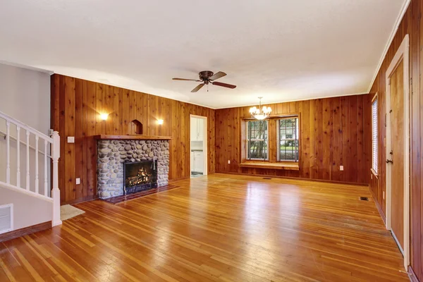 Leerer Raum mit Holzverkleidung, Hartholzboden und Kamin — Stockfoto