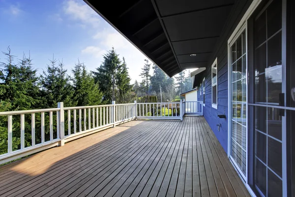 View of wooden walkout deck with white railings. — Stock Photo, Image