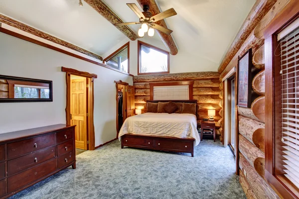 Log cabin bedroom with cherrywood furniture set. — Stock Photo, Image