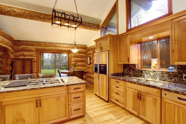 Log cabin kitchen interior design with honey color cabinets. — Stock Photo, Image