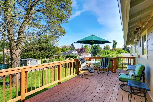 Walkout deck with patio table set and umbrella. — Stock Photo, Image