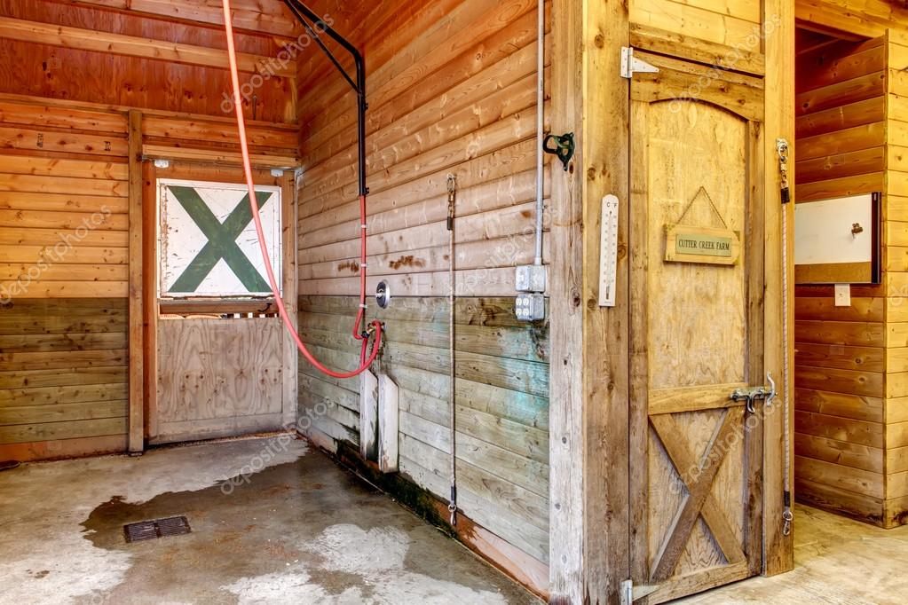 Stable Barn With Beam Ceiling And Open Door To A Clean Stall