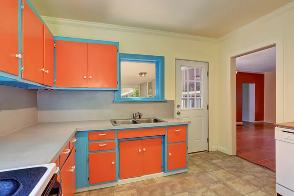 Old fashioned kitchen interior with orange and blue cabinets. — Stock Photo, Image