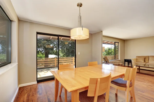 Dining room with maple table and exit to the deck. — Stock Photo, Image