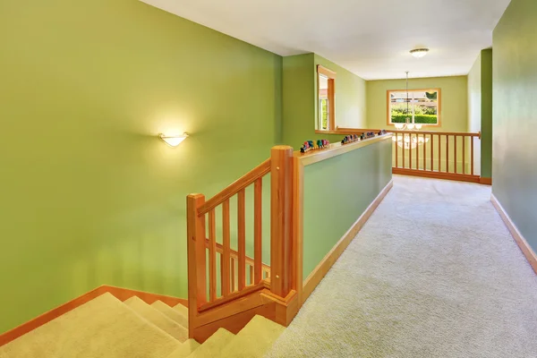 Green hallway interior with carpet floor and staircase. — Stock Photo, Image