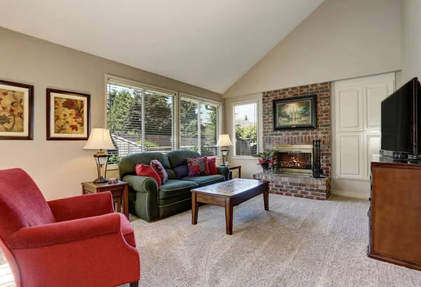 Traditional living room interior with green sofa and brick fireplace. — Stock Photo, Image