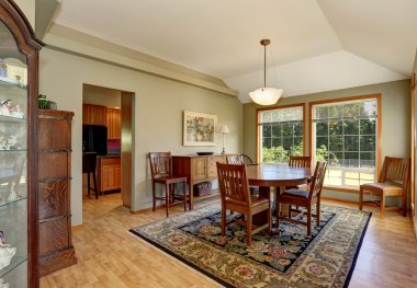 Halı ve büyük pencereler ile geleneksel yemek odası iç.