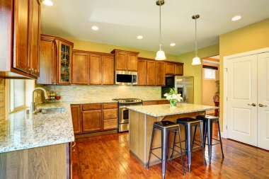 Wooden kitchen interior with kitchen island and cabinets.