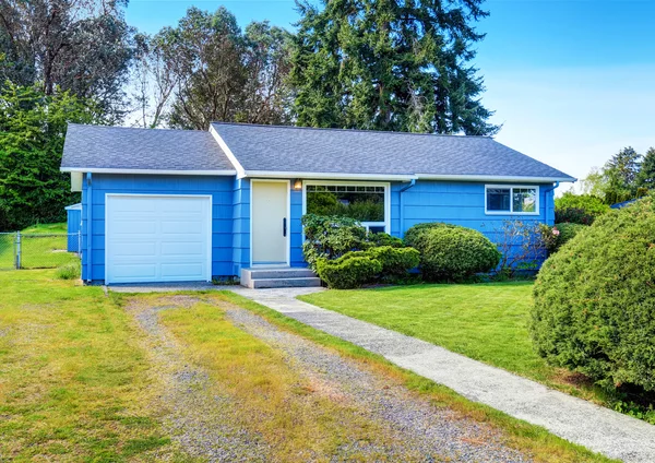 Kleine schattige blauwe huis met oprit en bijgesneden Hagen. — Stockfoto