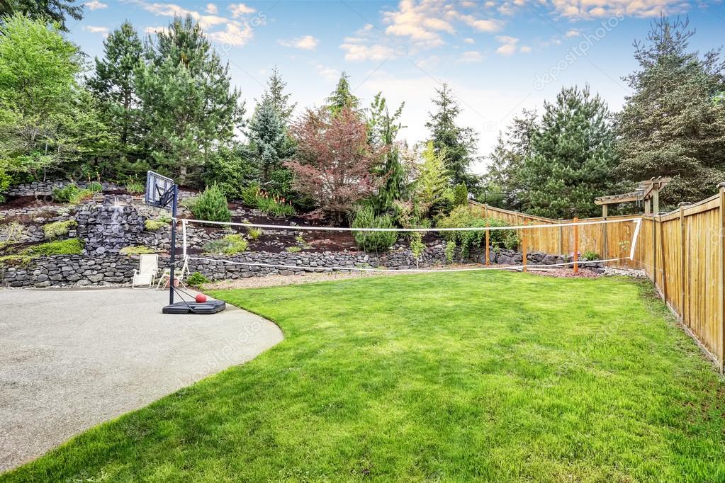 Backyard Well Kept Garden With Rocks Desing Basketball Hoop And