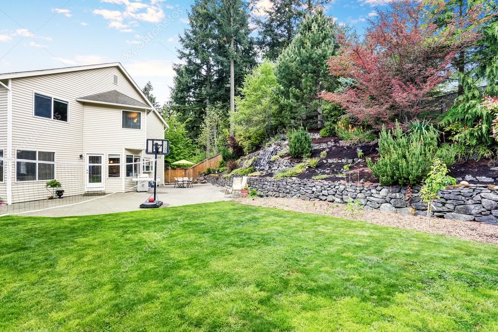 Backyard Well Kept Garden With Rocks Desing Basketball Hoop And