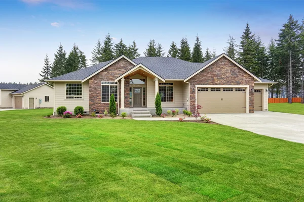 Luxury one level house exterior with brick trim and garage