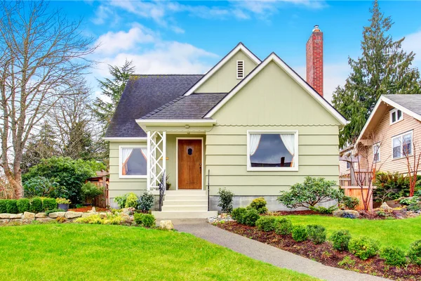 Small American house with well kept lawn and landscaping desing Stock Image