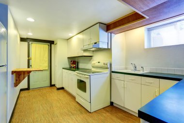 White basement kitchen room with green counter tops