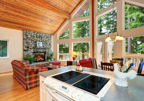 Open floor plan living room interior with rocks trim fireplace — Stock Photo, Image