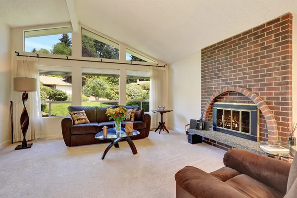 Spacious living room interior with brick fireplace — Stock Photo, Image