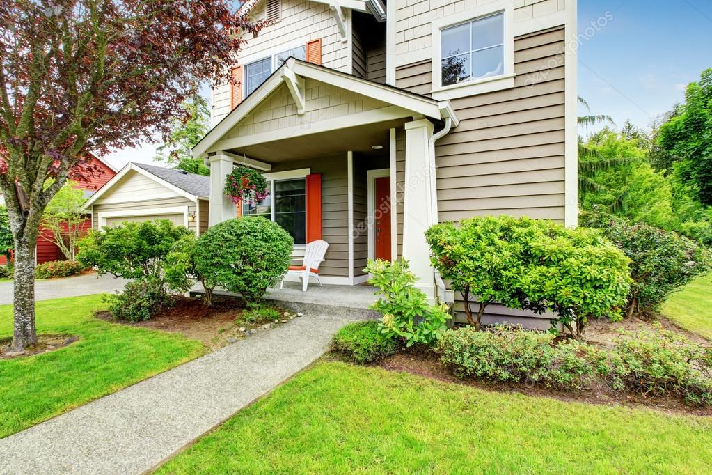 House exterior with siding trim, red entry door and concrete walkway ... House exterior with siding trim, red entry door and concrete walkway ...