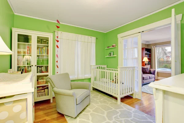 Kids room in white and green tones with beige armchair — Stock Photo, Image