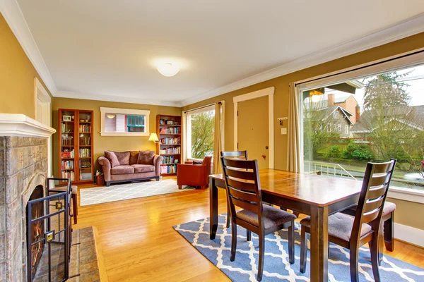 Cozy dining area with fireplace connected to comfortable home library — Stock Photo, Image