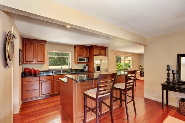 Wooden kitchen interior with kitchen island and steel appliances — Stok fotoğraf