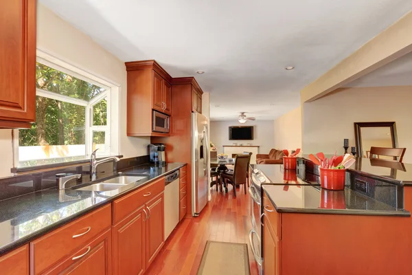 Wooden kitchen interior with kitchen island and steel appliances — Stok fotoğraf