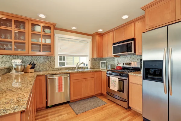 Bright wooden kitchen interior with steel appliances — Stock Photo, Image