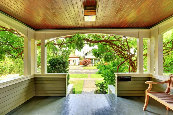 Cozy covered porch interior with wooden bench. — Stock Photo, Image